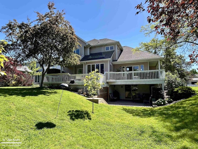 1080 Highland Dr, Saint Clair, MI 48079 - back of house with a patio, a deck, a lawn, and a shingled roof