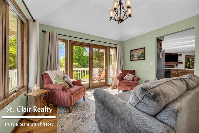 1080 Highland Dr, Saint Clair, MI 48079 - living room with a chandelier, wood finished floors, and lofted ceiling