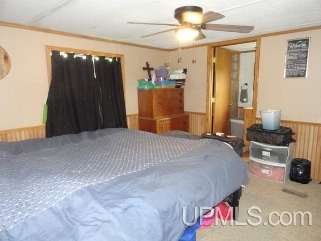 2801 M-94 Hwy, Eben Junction, MI 49825 - carpeted bedroom featuring wainscoting, crown molding, and ceiling fan