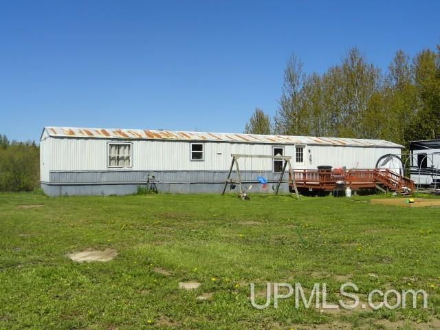 2801 M-94 Hwy, Eben Junction, MI 49825 - rear view of property with a lawn and a wooden deck