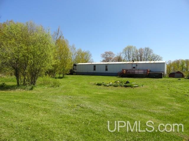 2801 M-94 Hwy, Eben Junction, MI 49825 - view of grassy yard with a wooden deck