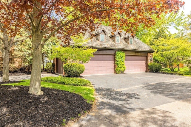 49016 Pointe Lakeview Dr, Chesterfield, MI 48047 - cape cod home featuring a garage and asphalt driveway