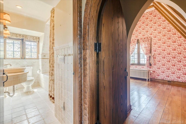 49016 Pointe Lakeview Dr, Chesterfield, MI 48047 - full bath with radiator, wallpapered walls, toilet, hardwood / wood-style floors, and tiled shower / bath