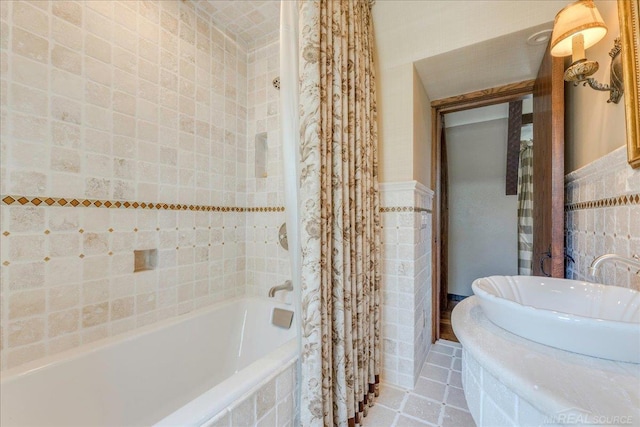 49016 Pointe Lakeview Dr, Chesterfield, MI 48047 - bathroom featuring tile walls, tiled shower / bath combo, a wainscoted wall, and tile patterned flooring