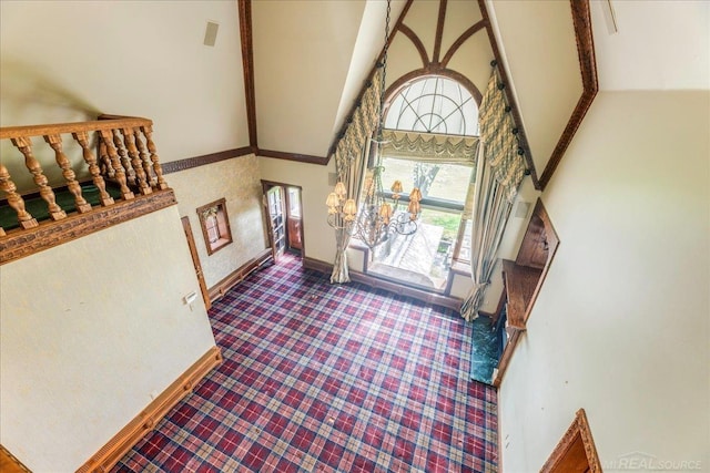 49016 Pointe Lakeview Dr, Chesterfield, MI 48047 - foyer entrance with high vaulted ceiling, baseboards, and carpet floors