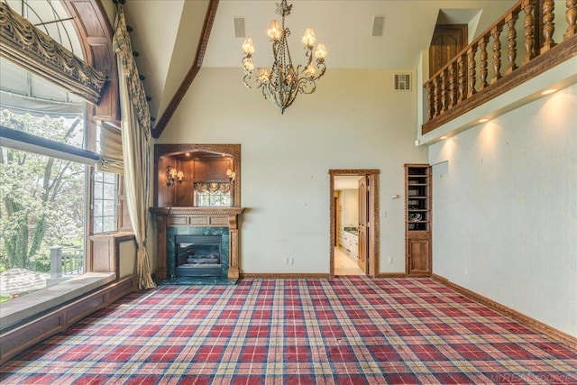 49016 Pointe Lakeview Dr, Chesterfield, MI 48047 - unfurnished living room featuring high vaulted ceiling, carpet flooring, a chandelier, plenty of natural light, and a glass covered fireplace