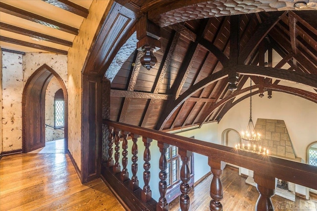 49016 Pointe Lakeview Dr, Chesterfield, MI 48047 - hall featuring arched walkways, a chandelier, wood-type flooring, baseboards, and beam ceiling