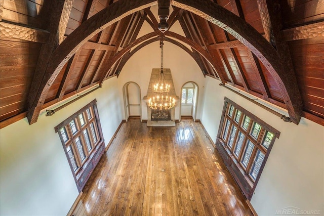 49016 Pointe Lakeview Dr, Chesterfield, MI 48047 - hall with arched walkways, high vaulted ceiling, beamed ceiling, a chandelier, and hardwood / wood-style flooring