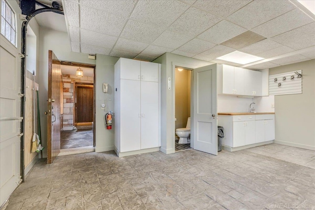 49016 Pointe Lakeview Dr, Chesterfield, MI 48047 - below grade area with a paneled ceiling, baseboards, and a sink