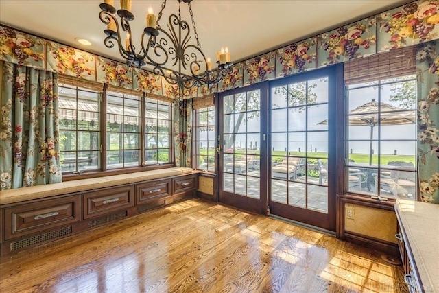 49016 Pointe Lakeview Dr, Chesterfield, MI 48047 - unfurnished sunroom with a chandelier, wood finished floors, and healthy amount of natural light