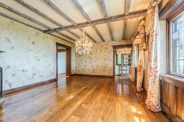 49016 Pointe Lakeview Dr, Chesterfield, MI 48047 - spare room with a chandelier, healthy amount of natural light, wood-type flooring, wallpapered walls, and beam ceiling