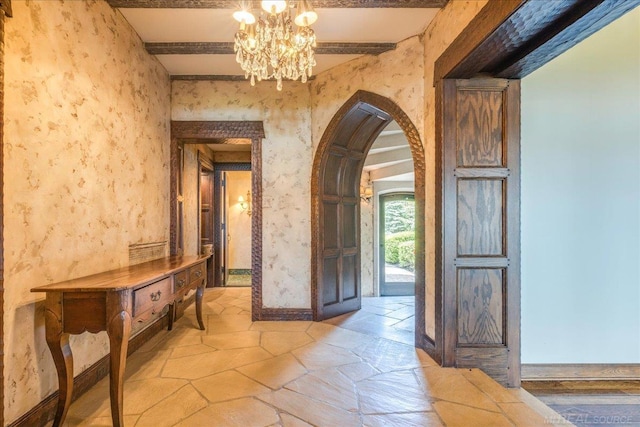 49016 Pointe Lakeview Dr, Chesterfield, MI 48047 - entrance foyer featuring arched walkways, baseboards, light stone finish floors, and a chandelier