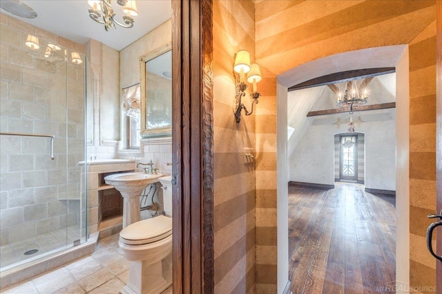 49016 Pointe Lakeview Dr, Chesterfield, MI 48047 - bathroom with a stall shower, toilet, a chandelier, wood finished floors, and a sink