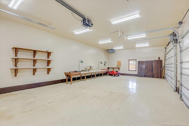49016 Pointe Lakeview Dr, Chesterfield, MI 48047 - garage featuring a garage door opener and baseboards
