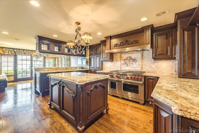 49016 Pointe Lakeview Dr, Chesterfield, MI 48047 - kitchen featuring double oven range, a chandelier, dark brown cabinets, a kitchen island, and wood finished floors