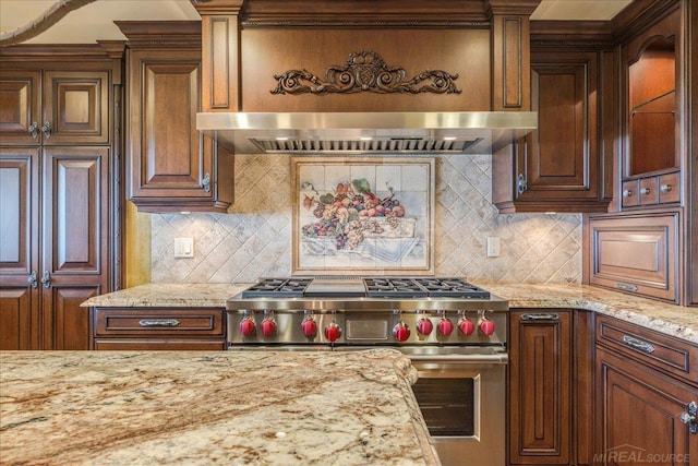 49016 Pointe Lakeview Dr, Chesterfield, MI 48047 - kitchen with premium range, range hood, light stone countertops, and tasteful backsplash