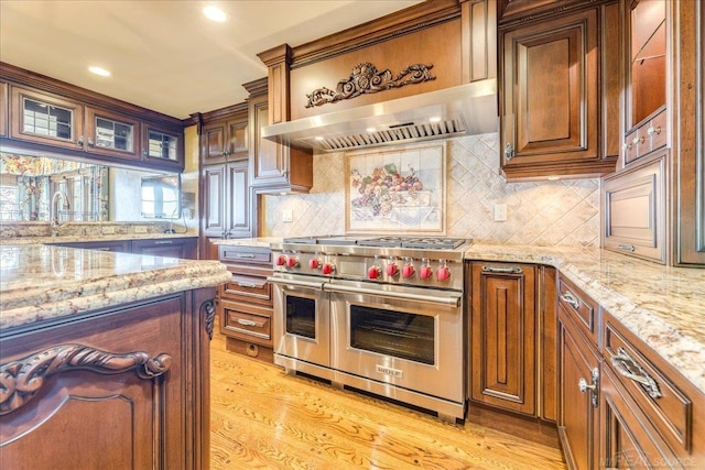 49016 Pointe Lakeview Dr, Chesterfield, MI 48047 - kitchen with range with two ovens, light stone counters, tasteful backsplash, light wood-style floors, and recessed lighting