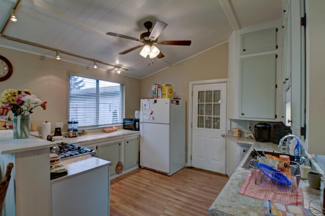 6669 Lakeshore Rd, Lexington, MI 48450 - kitchen featuring freestanding refrigerator, black microwave, a sink, light countertops, and track lighting