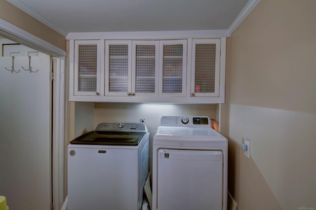 6669 Lakeshore Rd, Lexington, MI 48450 - washroom featuring washing machine and dryer, cabinet space, and ornamental molding