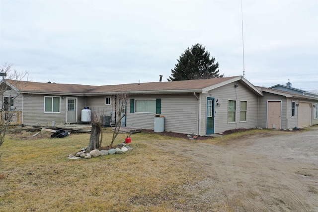 6669 Lakeshore Rd, Lexington, MI 48450 - back of house with a garage, central AC, a yard, and dirt driveway