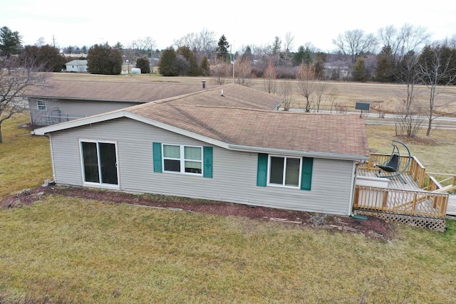 6669 Lakeshore Rd, Lexington, MI 48450 - rear view of house with a wooden deck, roof with shingles, and a lawn