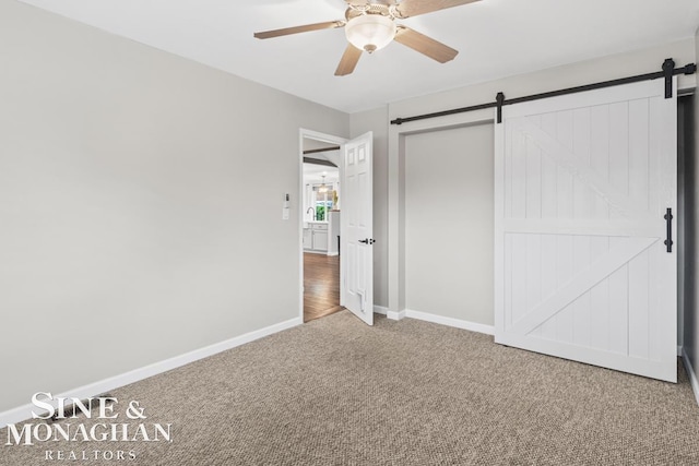 22574 Katzman St, Clinton Township, MI 48035 - unfurnished bedroom featuring a barn door, carpet flooring, baseboards, and a ceiling fan