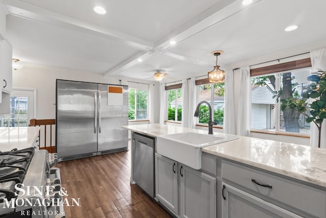 22574 Katzman St, Clinton Township, MI 48035 - kitchen featuring appliances with stainless steel finishes, a sink, dark wood-style flooring, healthy amount of natural light, and beamed ceiling