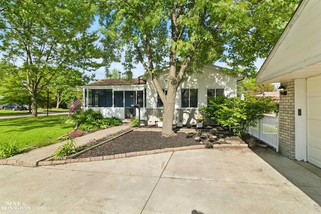 22574 Katzman St, Clinton Township, MI 48035 - view of front facade featuring a front yard, a sunroom, and brick siding