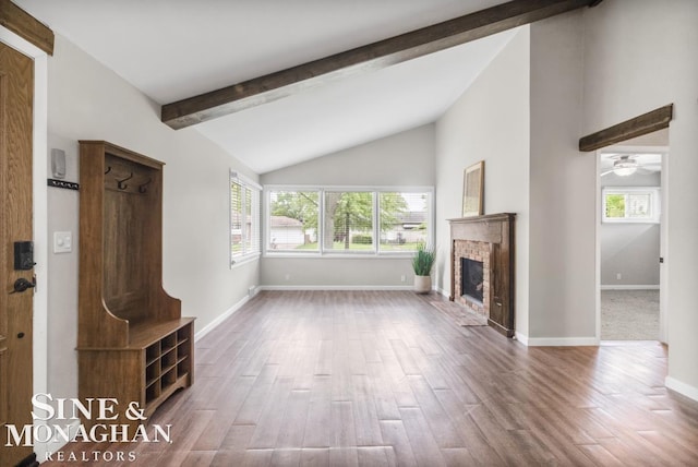 22574 Katzman St, Clinton Township, MI 48035 - unfurnished living room featuring healthy amount of natural light, wood finished floors, a brick fireplace, and baseboards