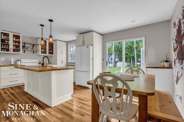 1923 Clinton Ave, Saint Clair, MI 48079 - kitchen featuring freestanding refrigerator, butcher block counters, range, white cabinets, and recessed lighting