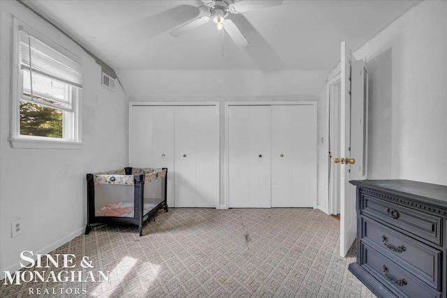 1923 Clinton Ave, Saint Clair, MI 48079 - bedroom with multiple closets, vaulted ceiling, a ceiling fan, and carpet