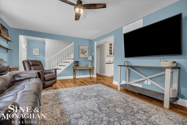 1923 Clinton Ave, Saint Clair, MI 48079 - living room featuring ceiling fan, stairs, wood finished floors, and baseboards