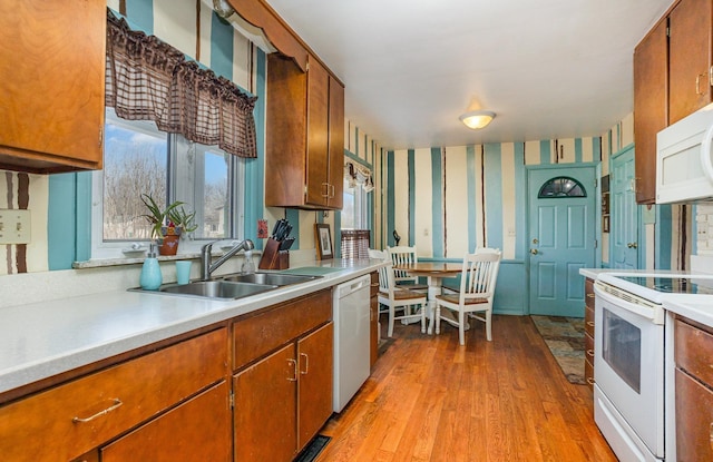 5149 Reinhardt Ln, Bay City, MI 48706 - kitchen with white appliances, wallpapered walls, light countertops, and brown cabinets
