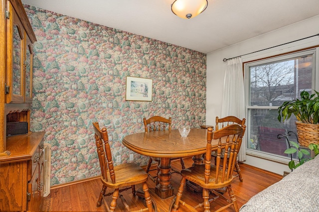 5149 Reinhardt Ln, Bay City, MI 48706 - dining area featuring wallpapered walls, light wood-style floors, and baseboards