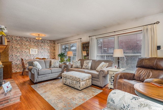 5149 Reinhardt Ln, Bay City, MI 48706 - living area featuring wallpapered walls, wood-type flooring, a textured ceiling, and baseboards