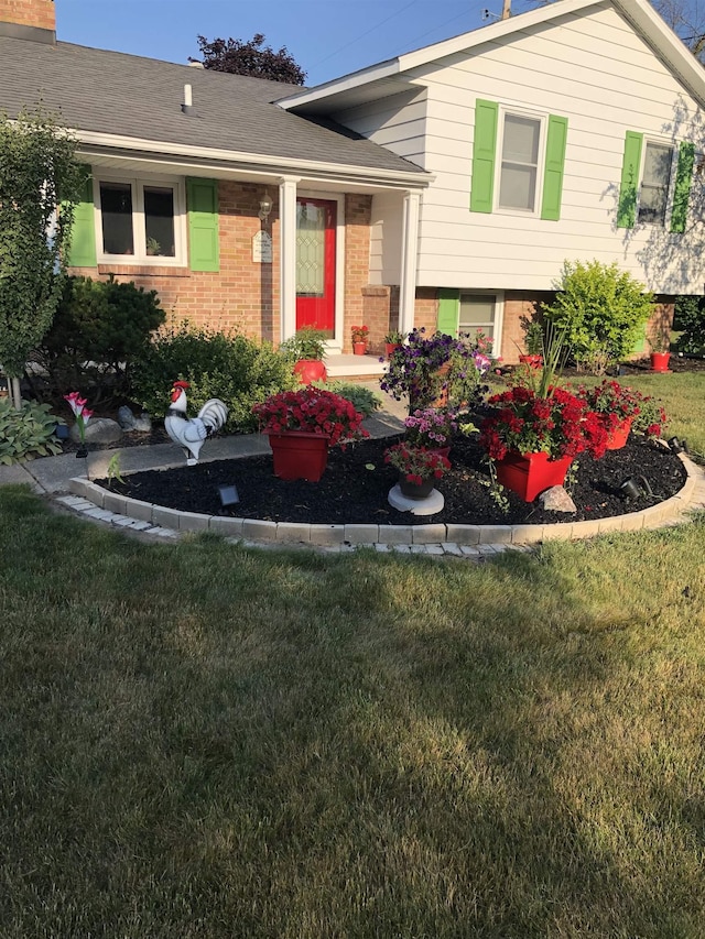 5149 Reinhardt Ln, Bay City, MI 48706 - view of front of house featuring brick siding and a front yard