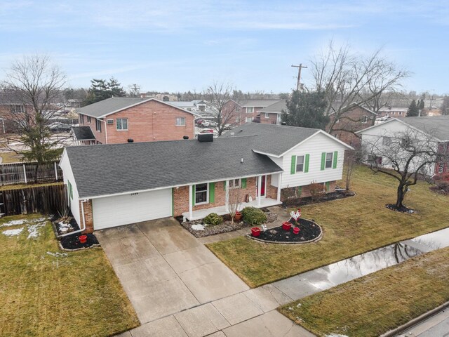 5149 Reinhardt Ln, Bay City, MI 48706 - split level home with a residential view, driveway, brick siding, covered porch, and roof with shingles