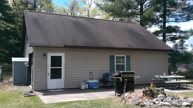 7880 S Dyer Dr, Falmouth, MI 49632 - rear view of property with a patio and a shingled roof