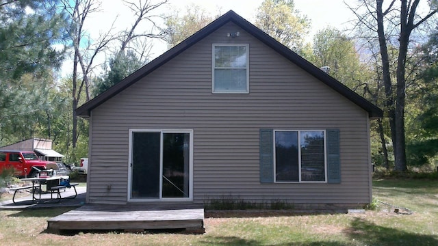 7880 S Dyer Dr, Falmouth, MI 49632 - rear view of house with a deck and a yard