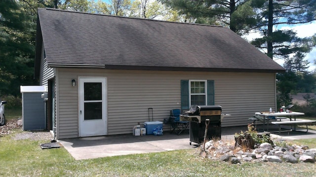 7880 S Dyer Dr, Falmouth, MI 49632 - back of house featuring a patio area and roof with shingles
