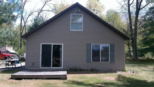 7880 S Dyer Dr, Falmouth, MI 49632 - back of house featuring a yard and a deck