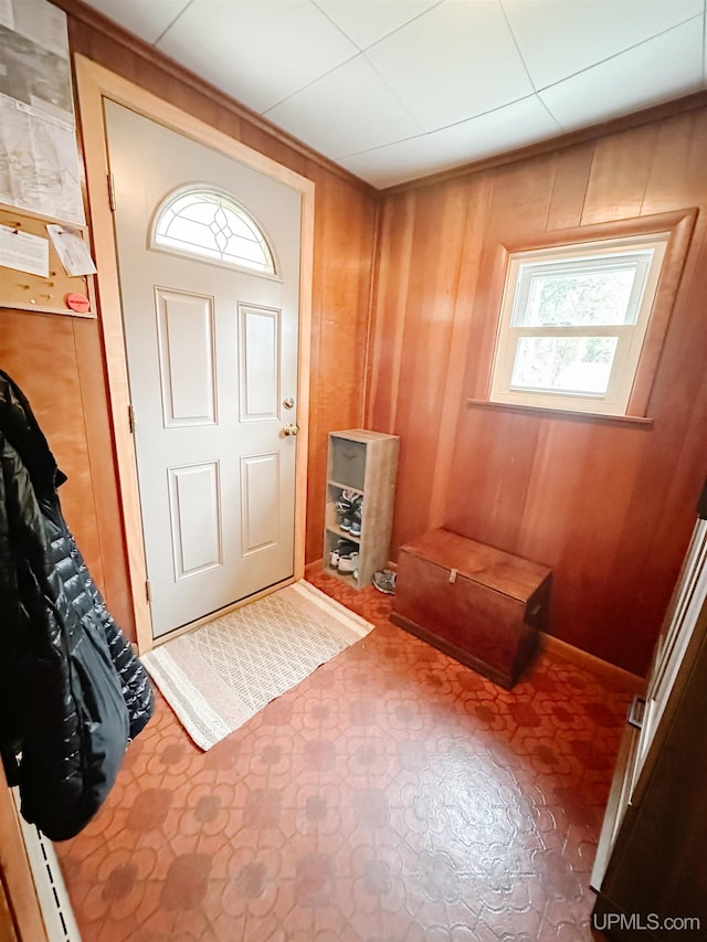 812 Spruce St, Marquette, MI 49855 - entryway featuring wood walls and tile patterned floors