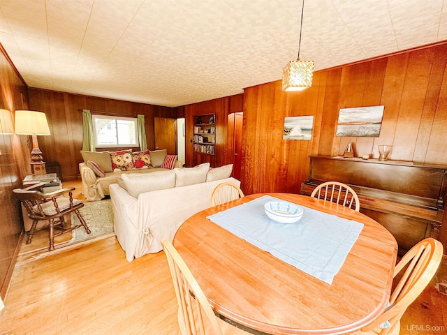 812 Spruce St, Marquette, MI 49855 - dining room featuring wood walls and light wood-type flooring