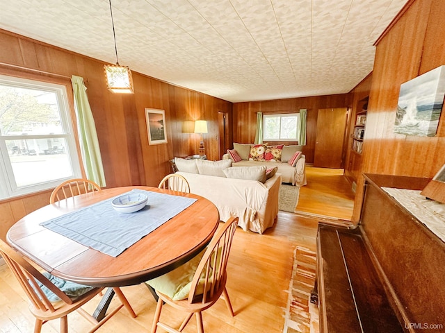 812 Spruce St, Marquette, MI 49855 - dining room featuring wooden walls and light wood-style floors