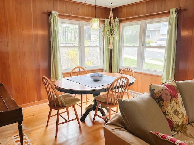 812 Spruce St, Marquette, MI 49855 - dining space featuring wooden walls, plenty of natural light, and light wood-style floors
