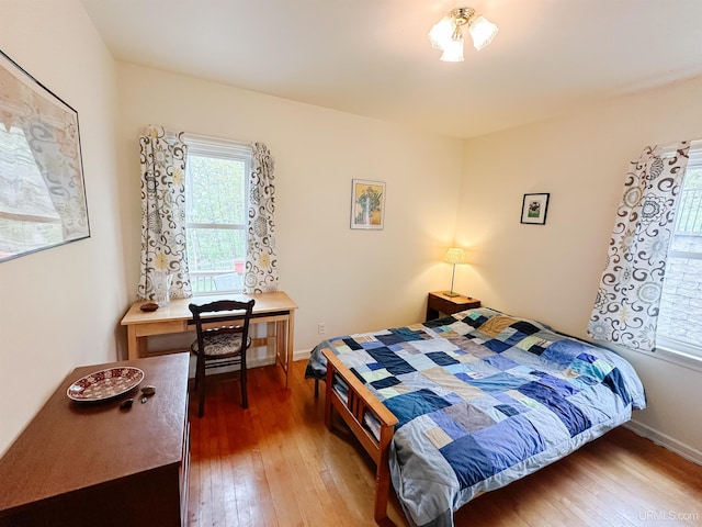 812 Spruce St, Marquette, MI 49855 - bedroom featuring wood-type flooring and baseboards