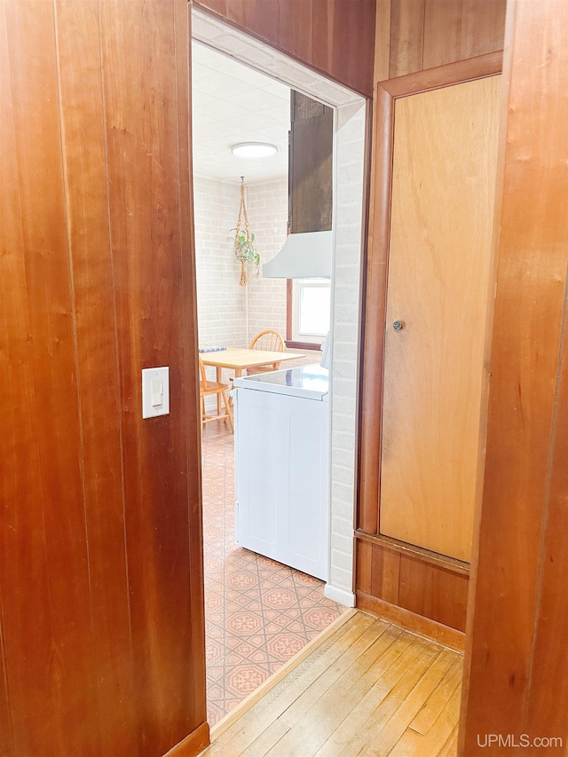 812 Spruce St, Marquette, MI 49855 - corridor featuring light wood-style flooring, washer / clothes dryer, and wood walls
