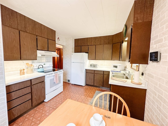 812 Spruce St, Marquette, MI 49855 - kitchen with white appliances, under cabinet range hood, a sink, and light countertops