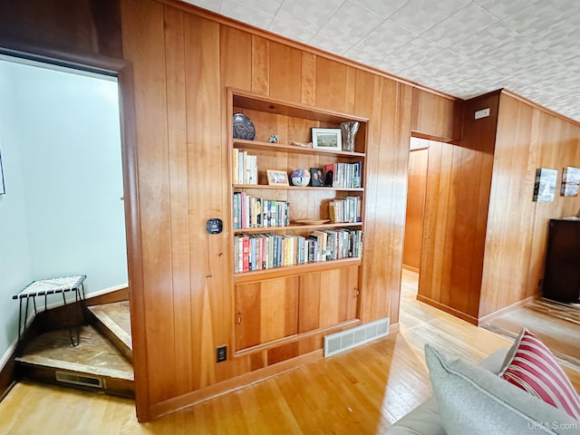 812 Spruce St, Marquette, MI 49855 - living area featuring wood walls, wood finished floors, and baseboards