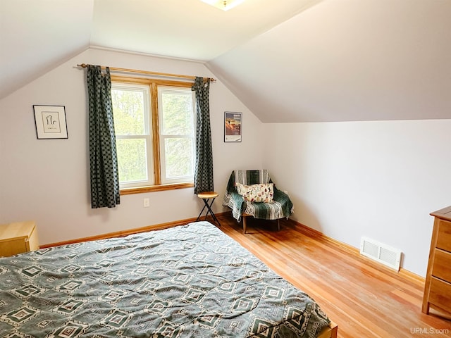812 Spruce St, Marquette, MI 49855 - living area with wood finished floors, vaulted ceiling, and baseboards